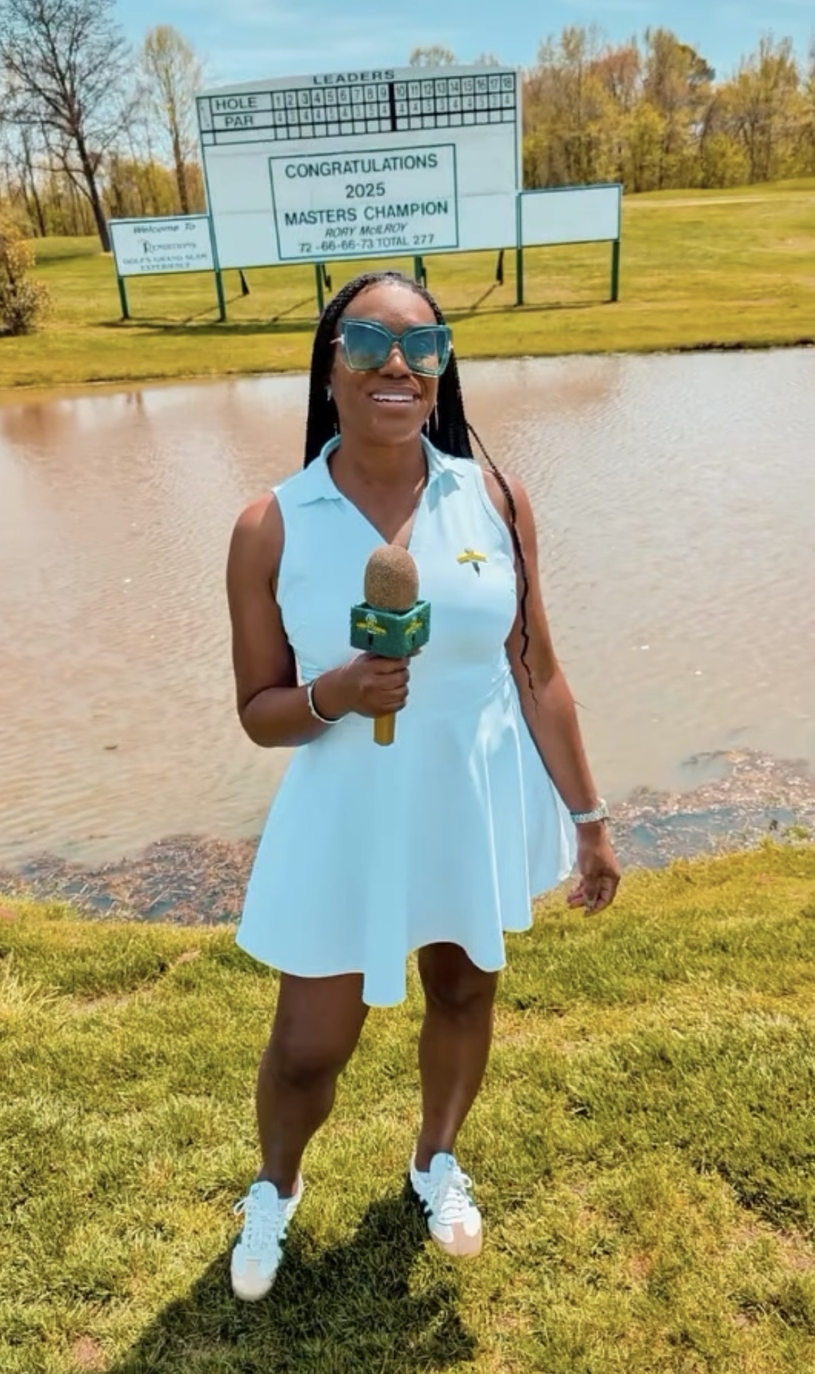 The Chipping Queen on the course with The Green Carpet Golf microphone in front of a tournament leaderboard.