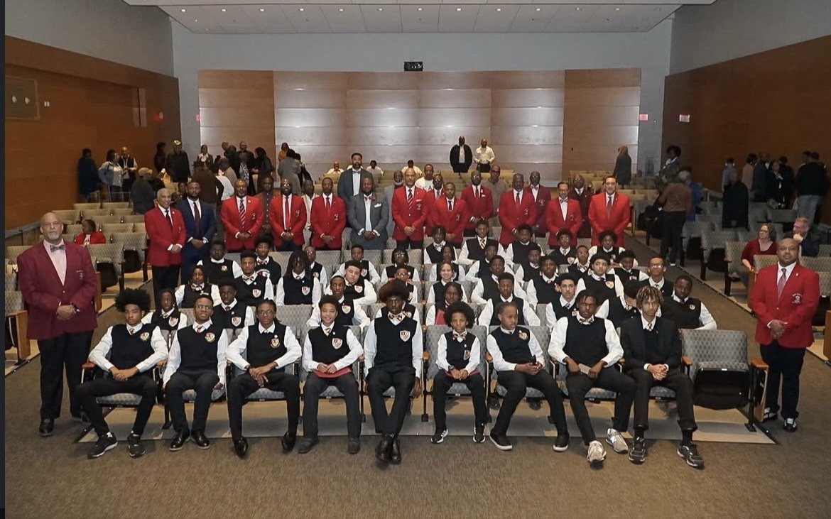 Kappa Leaguers in vests and ties in a courthouse hallway.