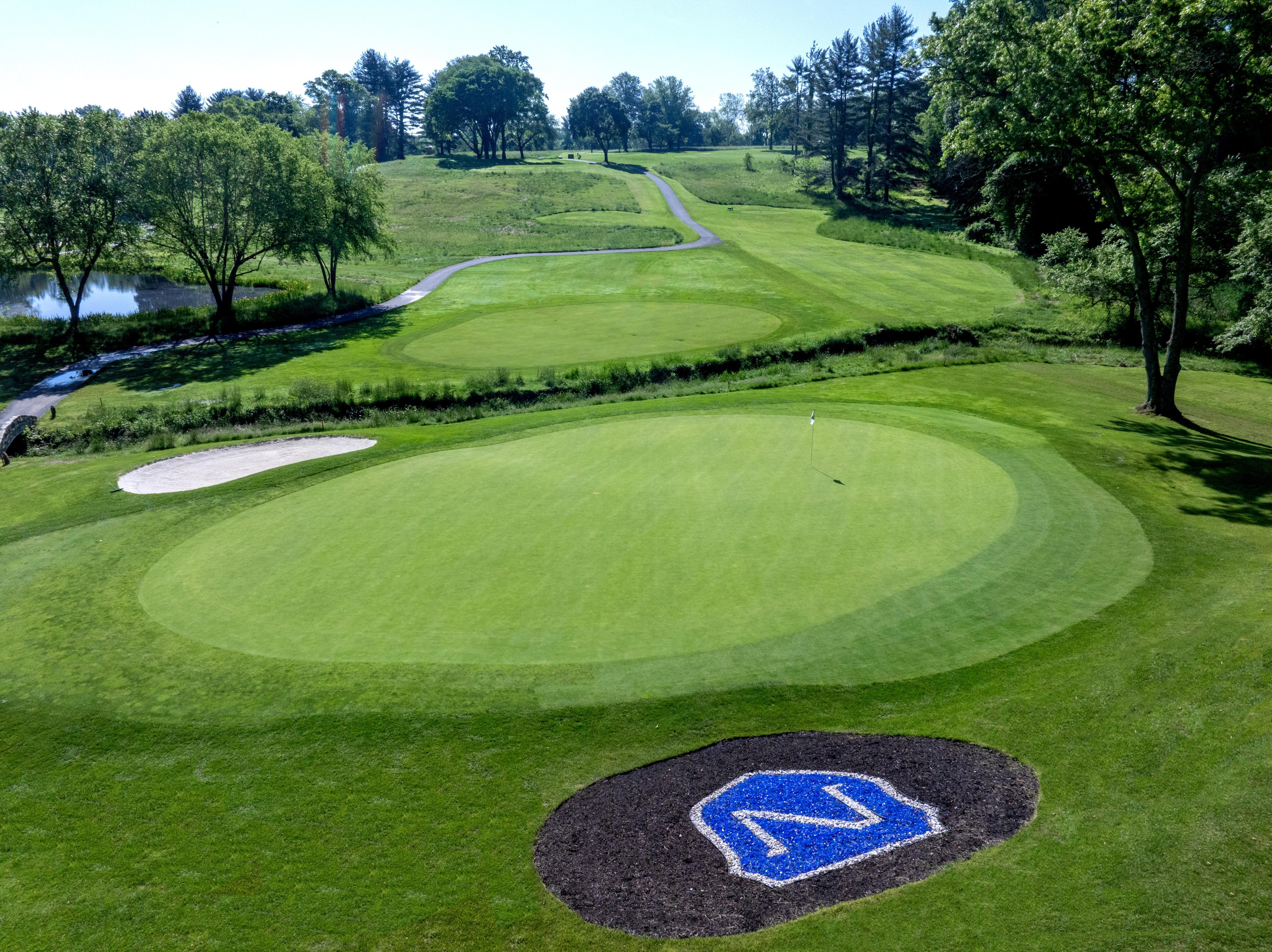 Aerial view of a Norbeck Country Club green and approach, with the signature 'N' emblem inlaid in the surround.